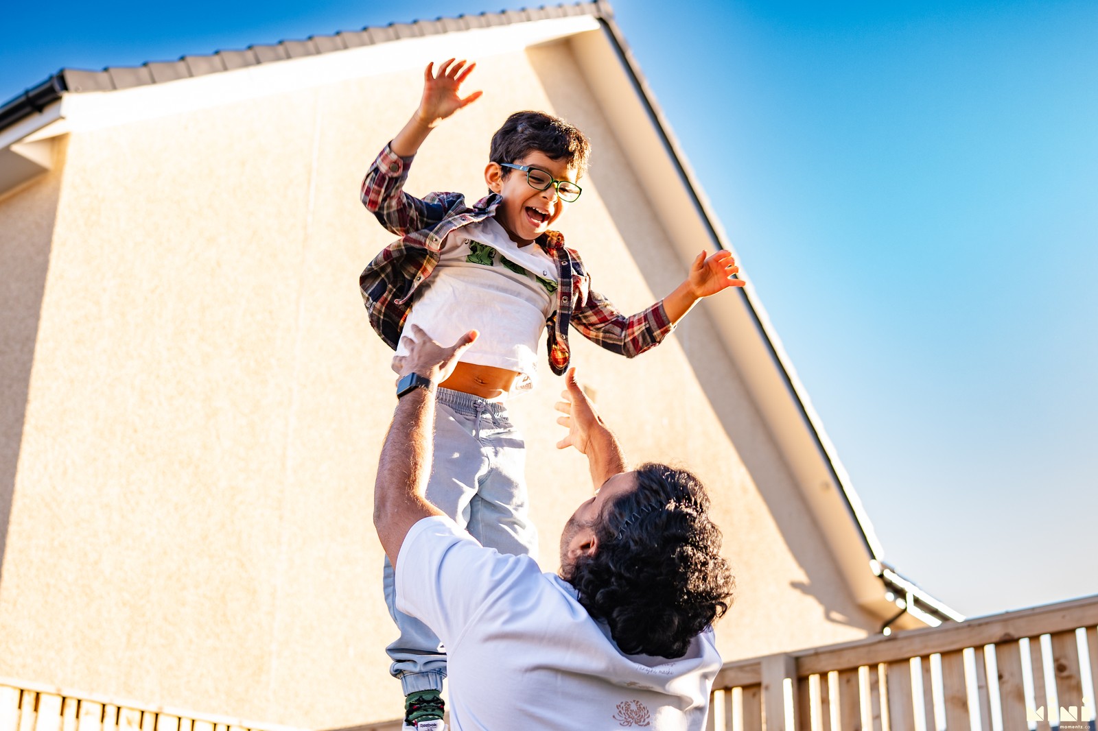 Father throwing child with joy — lifestyle family photography UK Mini Momentz
