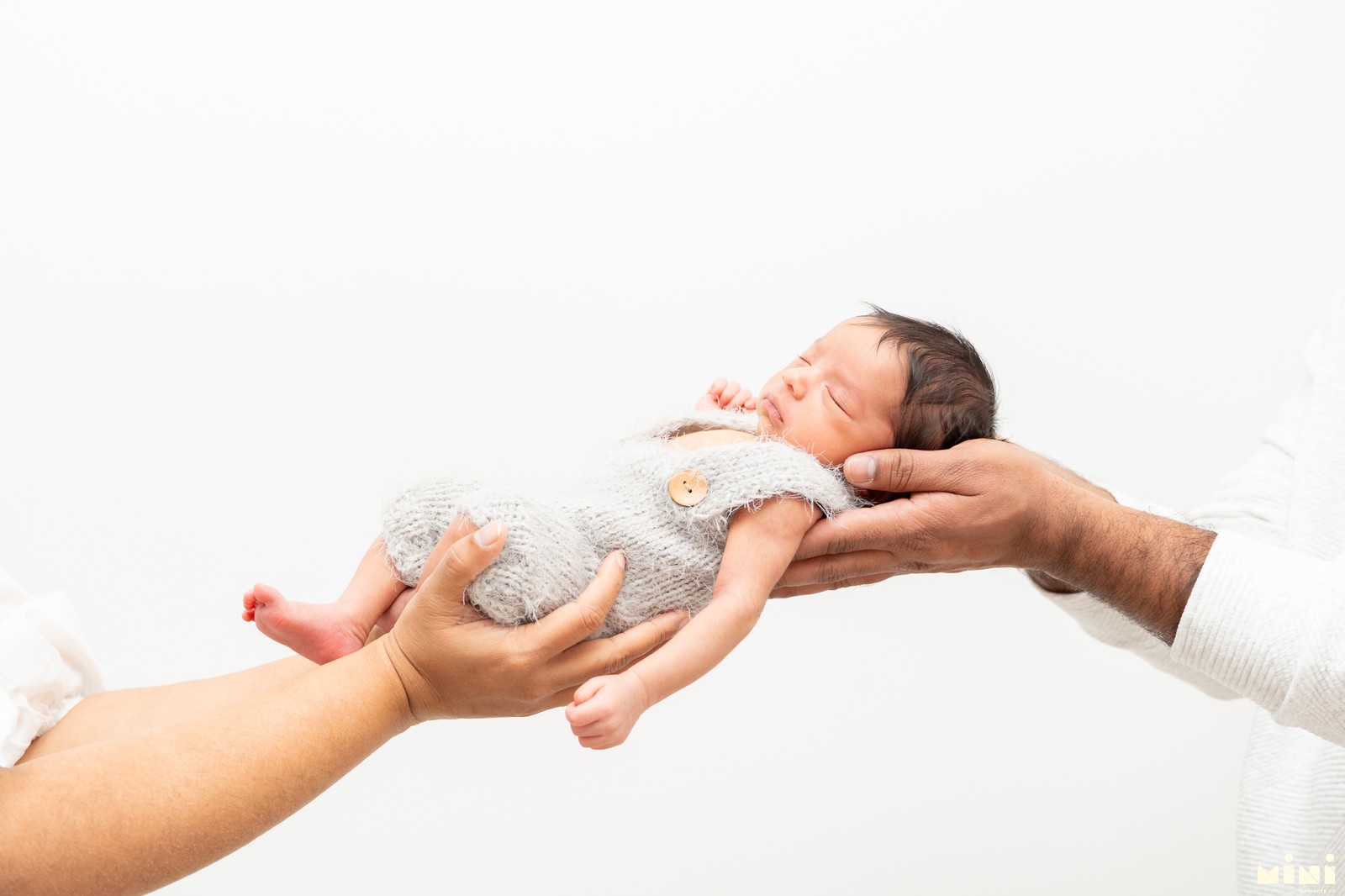 Parents holding newborn — home newborn photography Coventry Mini Momentz