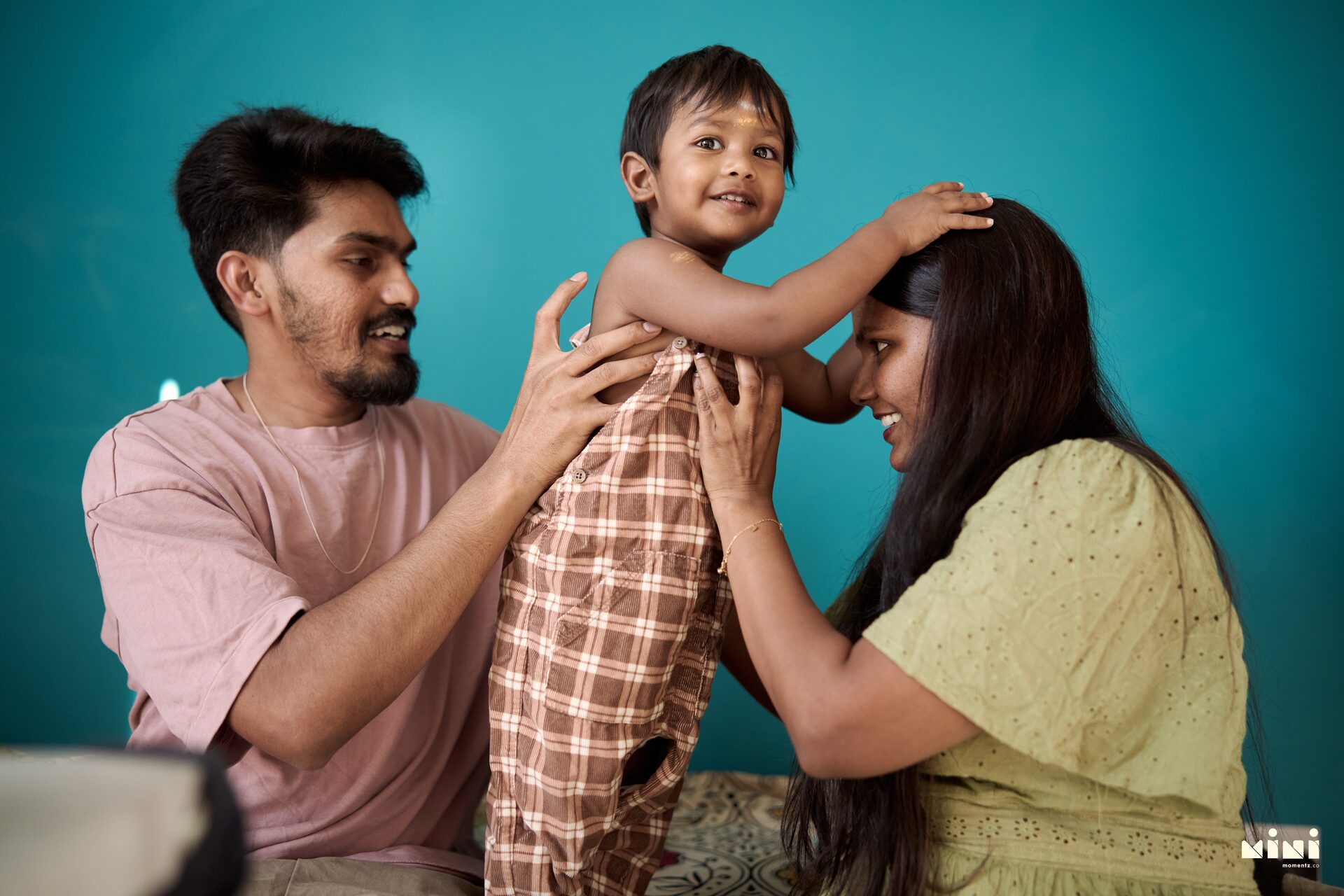 Harsha and Sravani dressing Aaru for his second birthday at home in Leicester — family photographer Mini Momentz