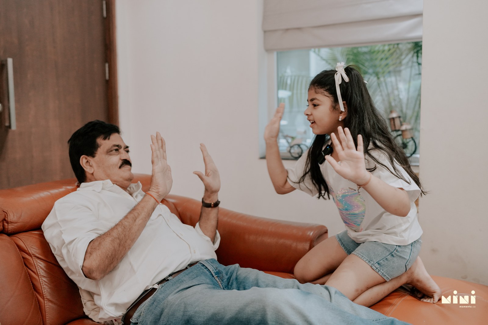 Grandfather playing with child during a family storytelling session