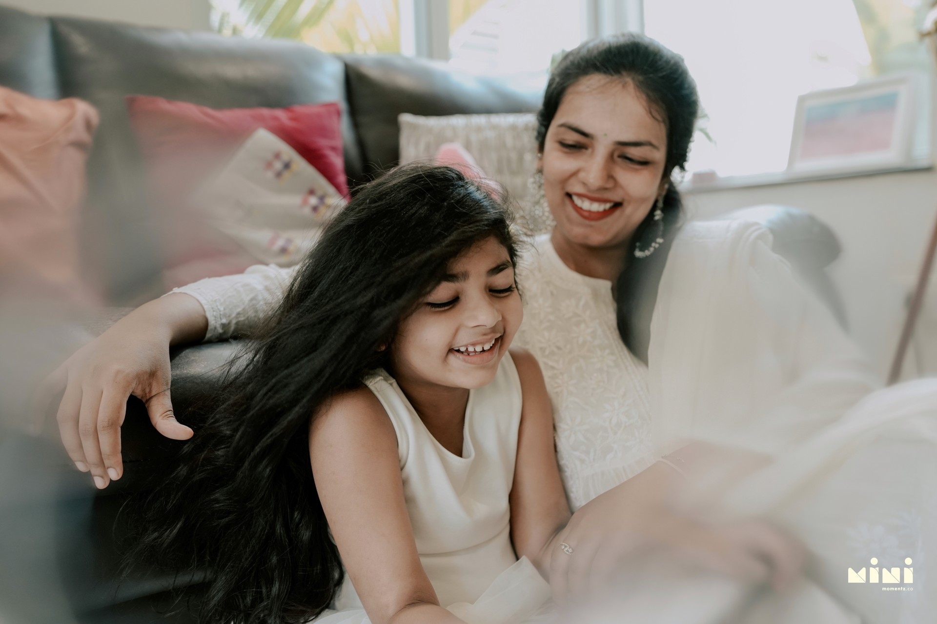 Deepti and her daughter laughing — a decade of family photography with Mini Momentz
