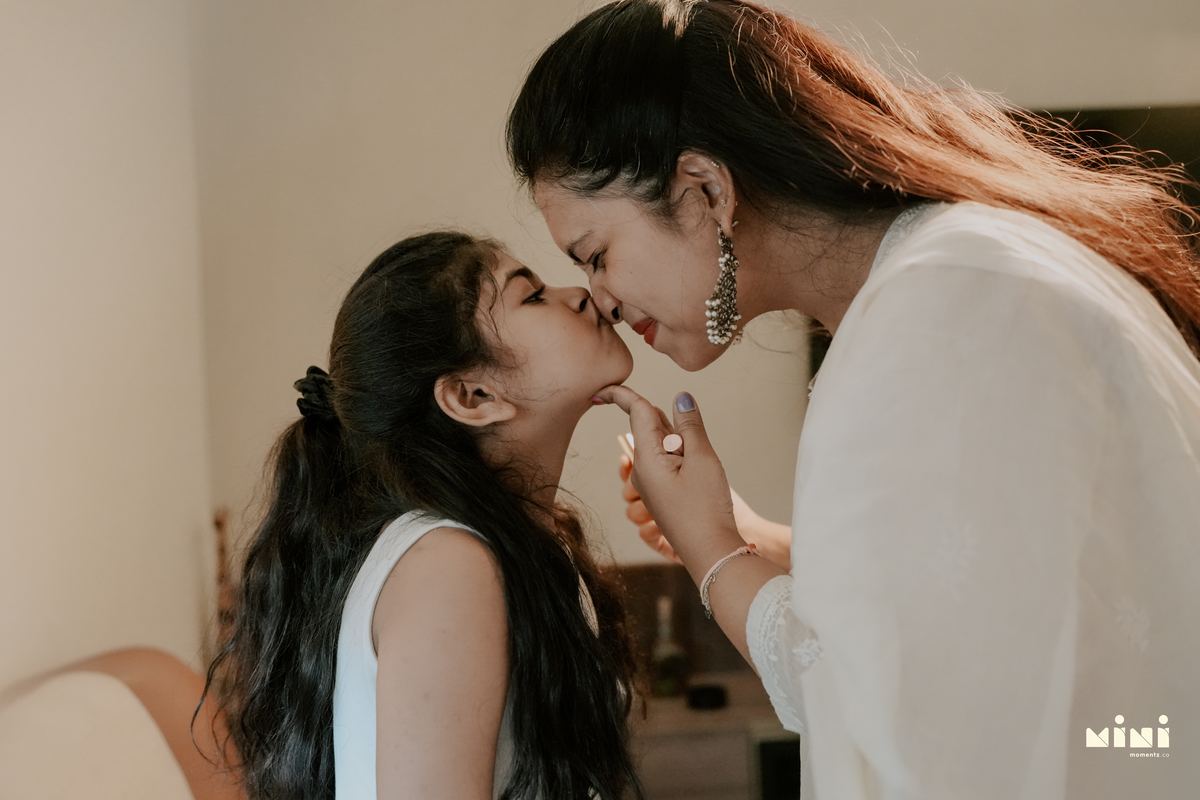 Deepti and her daughter nose to nose — an intimate mother and child moment during home lifestyle photography by Mini Momentz UK