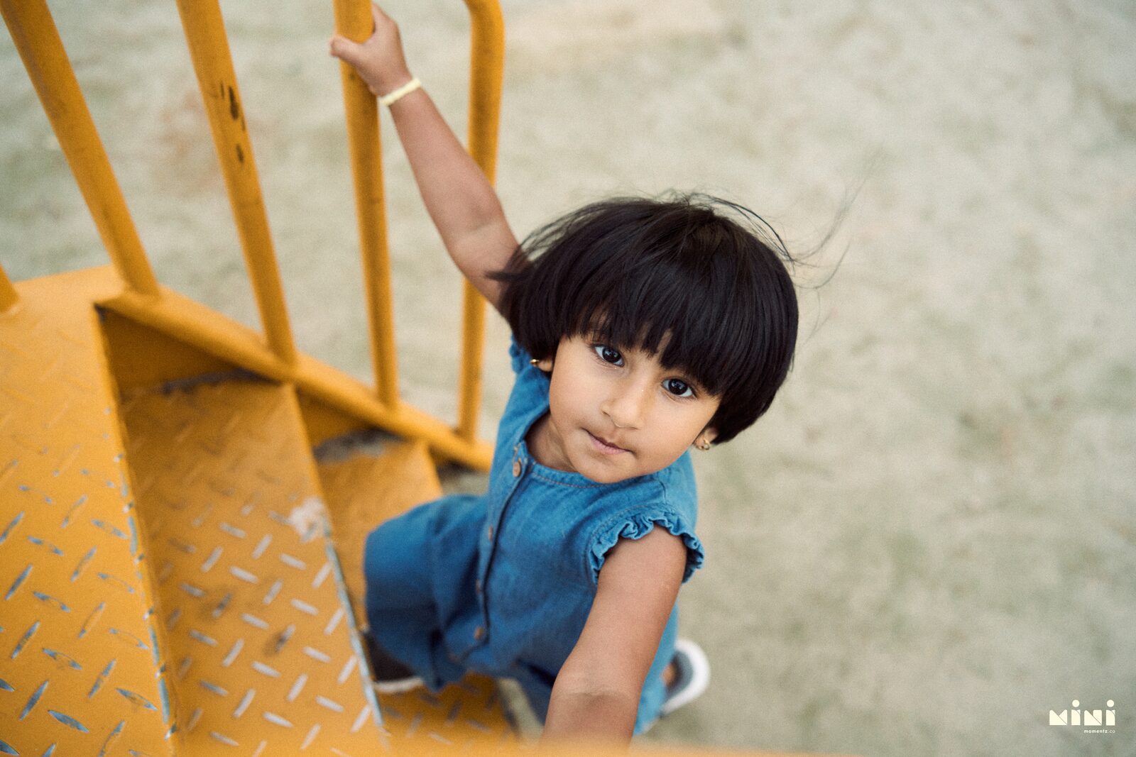 Child portrait on a yellow staircase