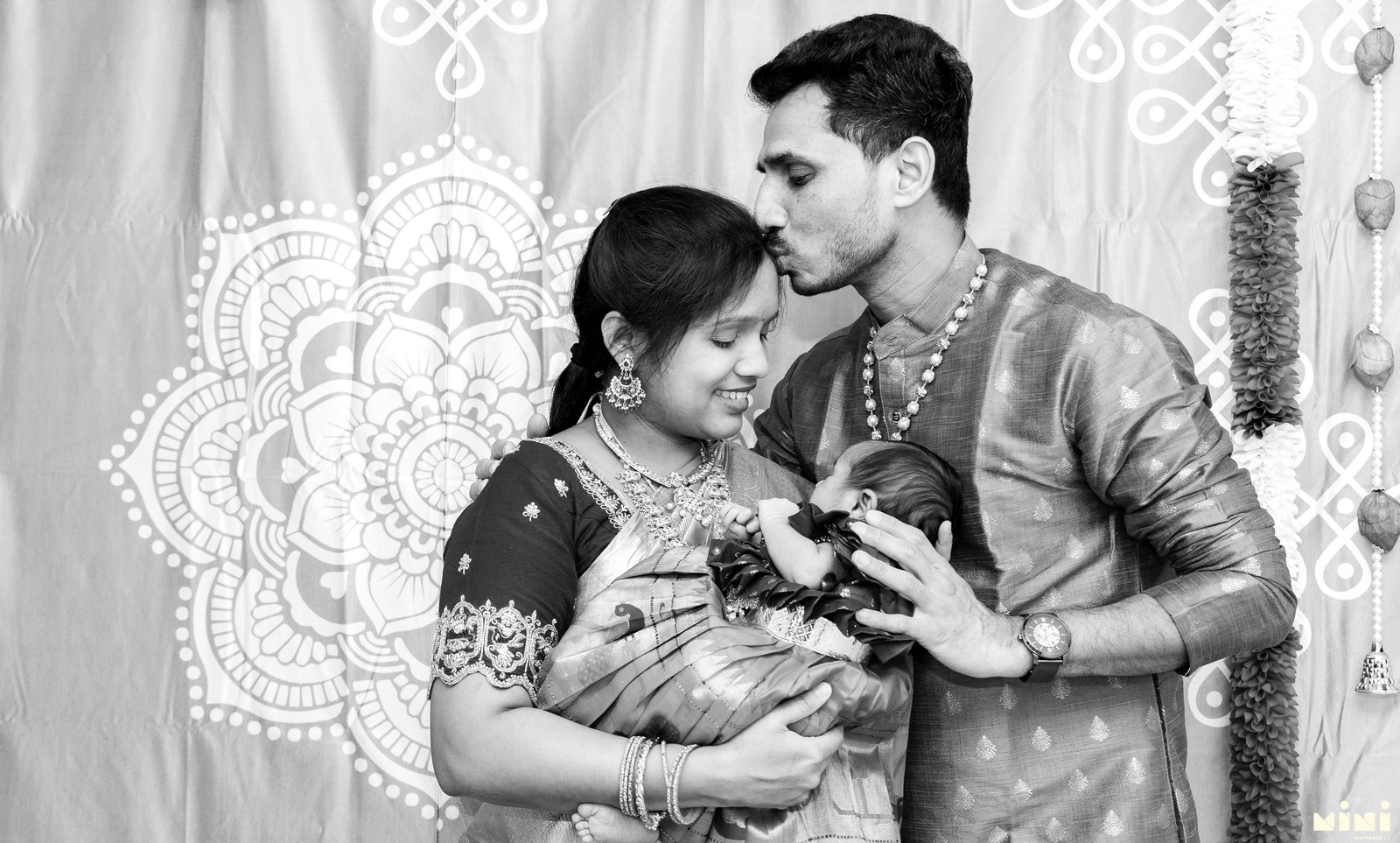 Black and white family moment during a naming ceremony