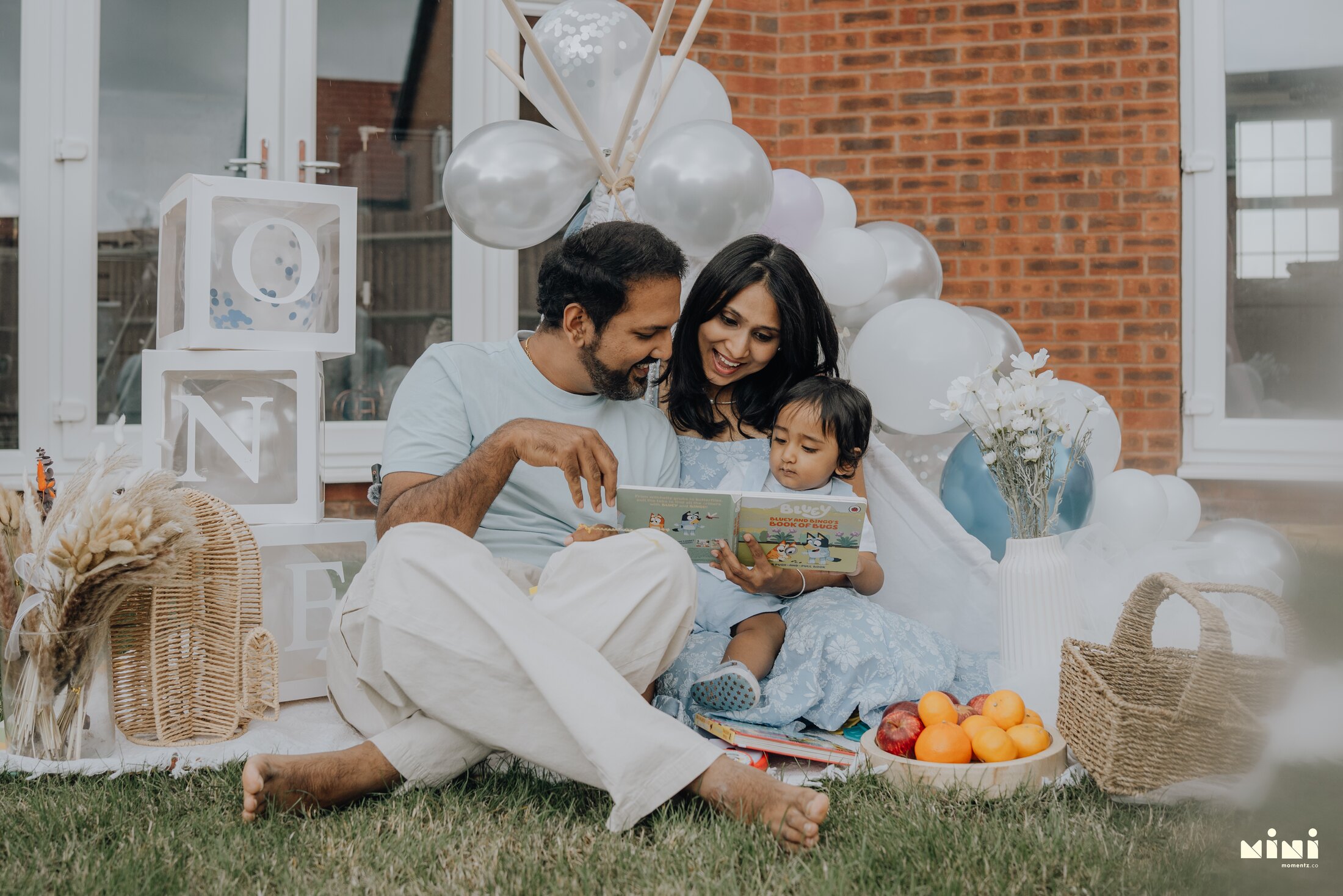 Ramesh, Seema and Sid reading together during their family session in Leicester