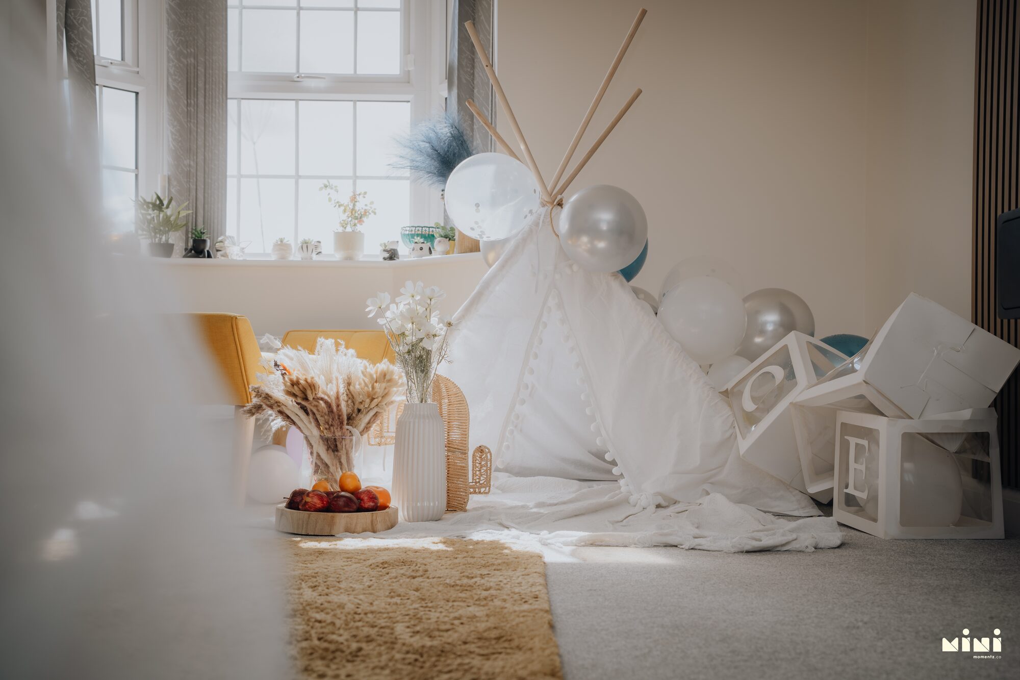 A quiet room prepared with a white teepee and balloons at home in Barkby Thorpe, Leicester, before the family arrived — Mini Momentz